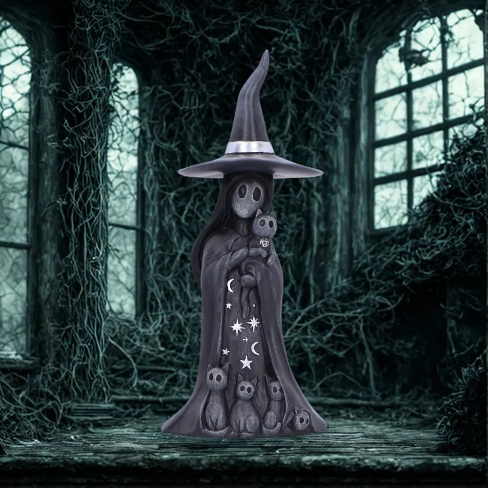 A Nemesis Now gothic witch figurine in a moonlit window setting.